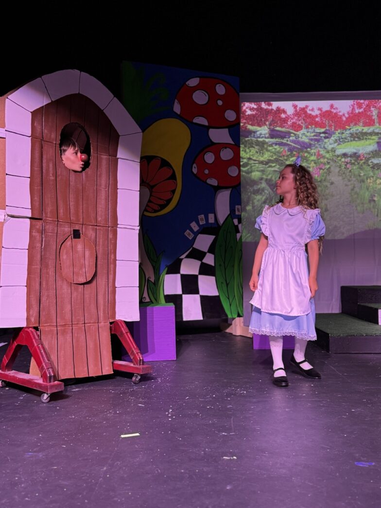 a group of children standing on top of a stage