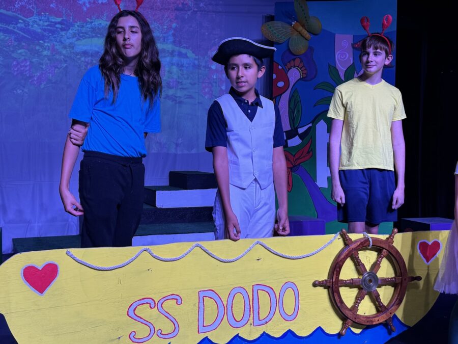 a group of children standing on top of a stage