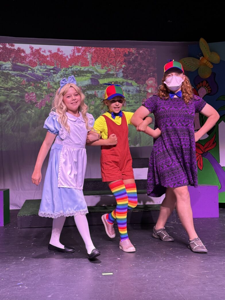 a group of children standing on top of a stage