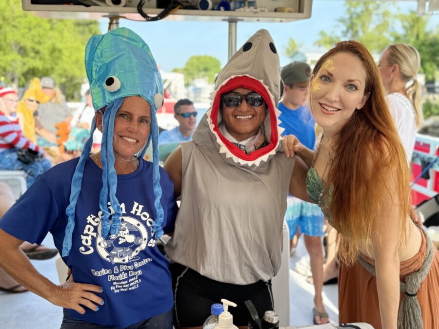 a group of people standing around a table with food on it