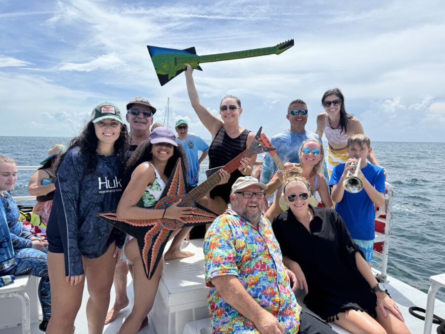 a group of people on a boat posing for a picture