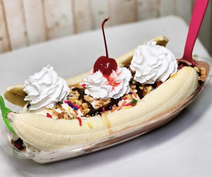 a banana split with whipped cream and a cherry on top