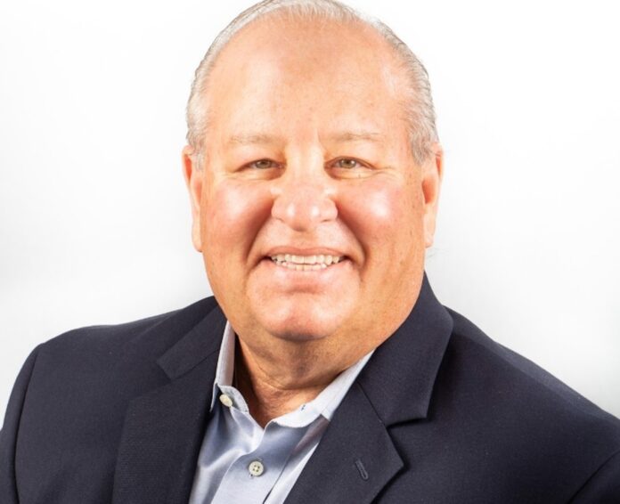 a man in a suit smiling at the camera