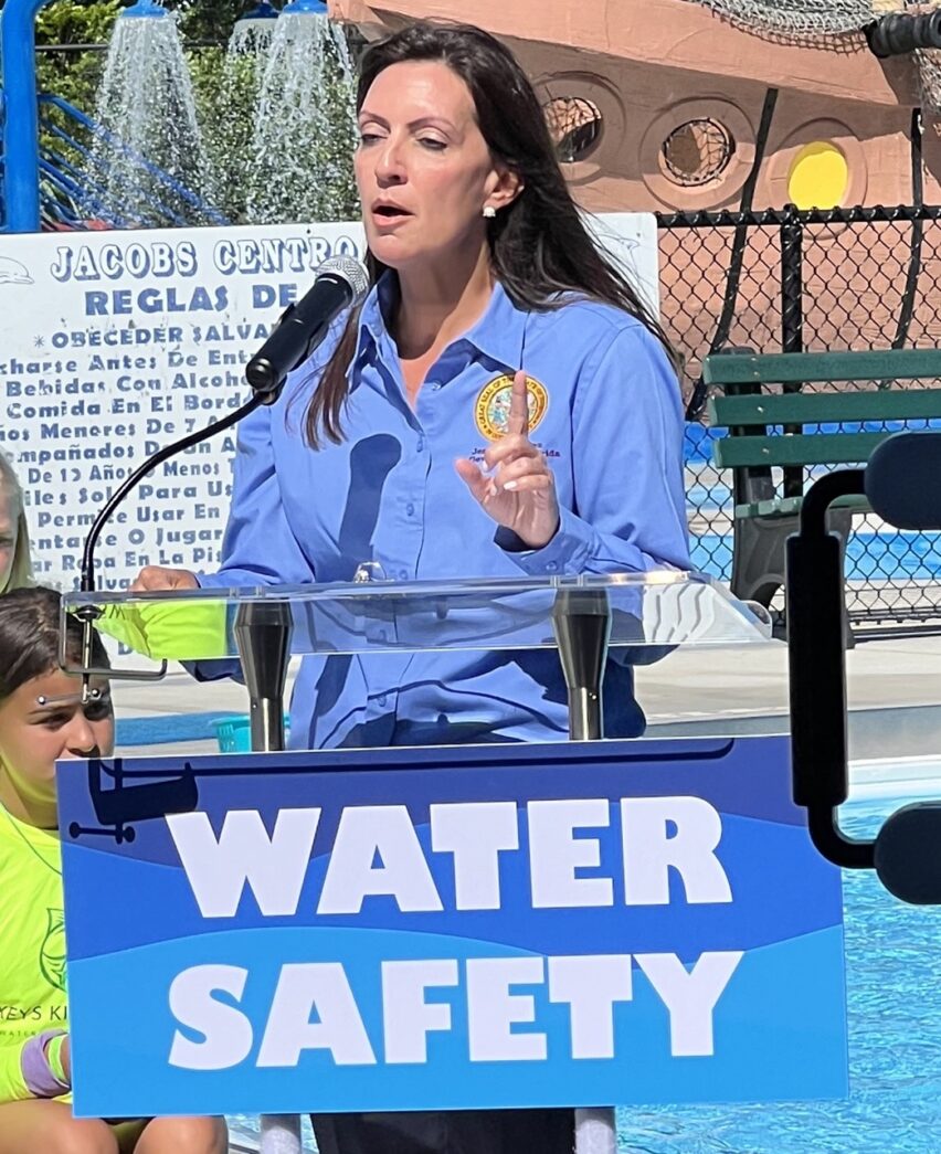 a woman standing at a podium with a microphone