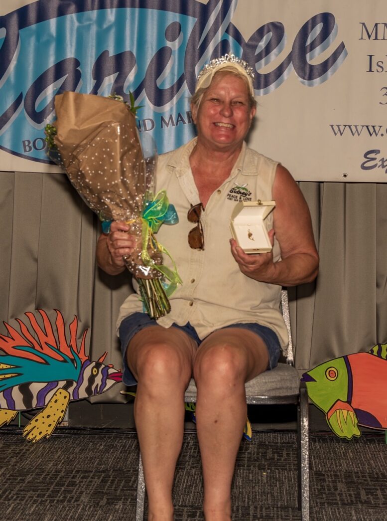 a woman sitting on a chair holding a bouquet of flowers