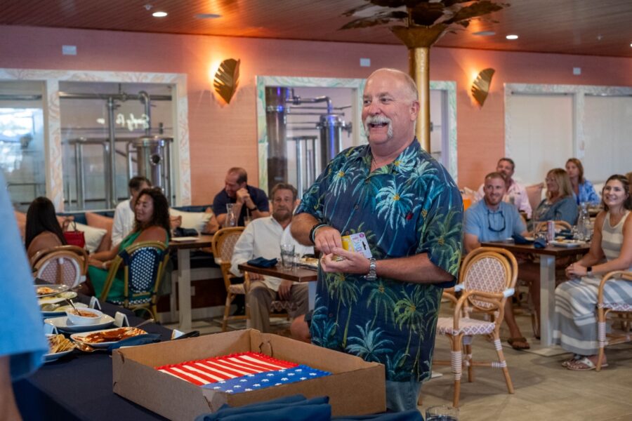 a man standing in front of a table with a cake on it
