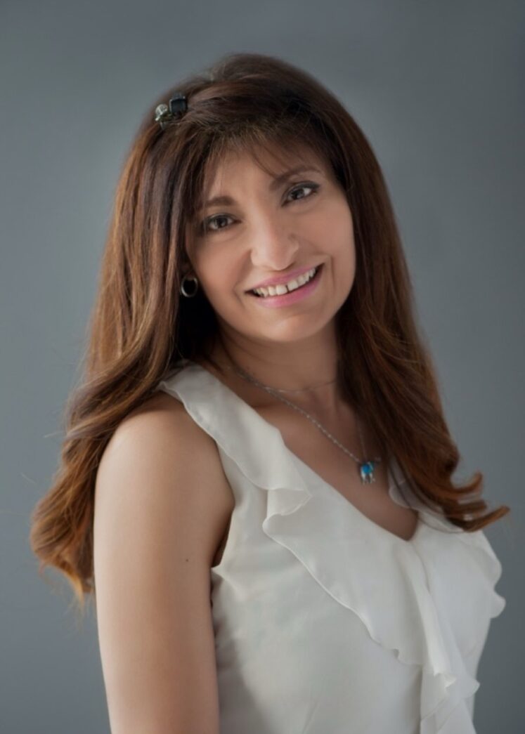 a woman in a white dress posing for a picture