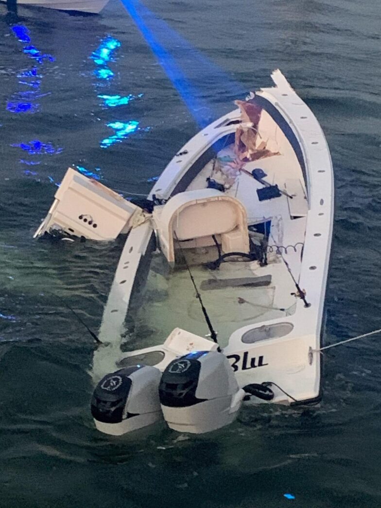 a man sitting on top of a boat in the water