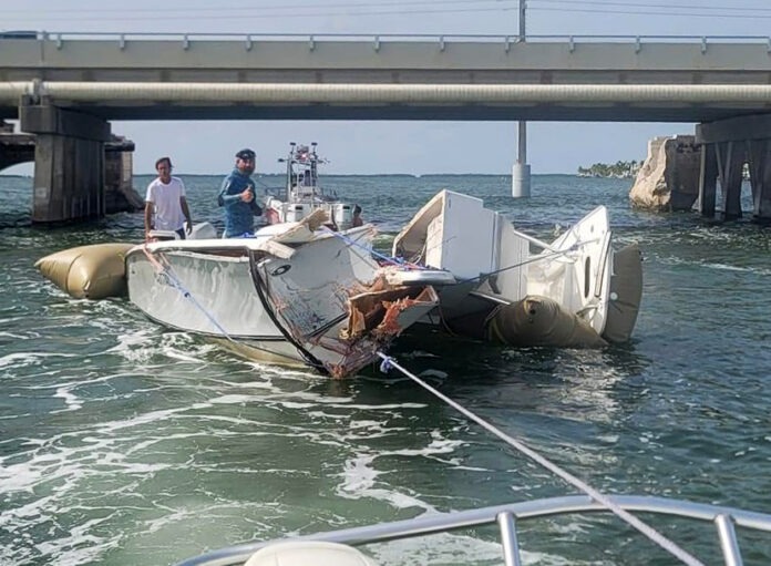 a boat in the water with a bridge in the background