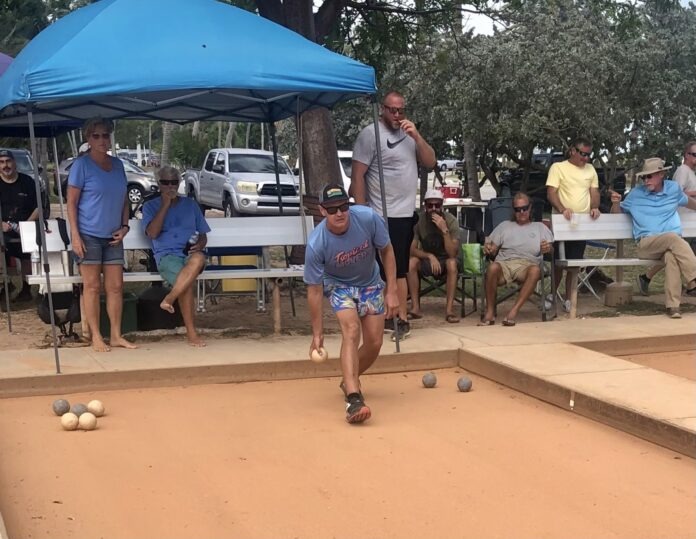 a group of people playing a game of bowling