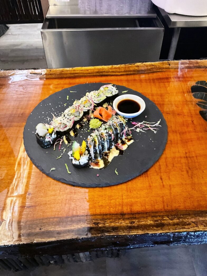 a plate of food sitting on top of a wooden table