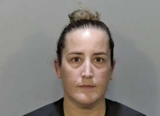 a mug shot of a woman in a black shirt