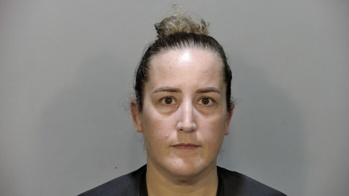 a mug shot of a woman in a black shirt