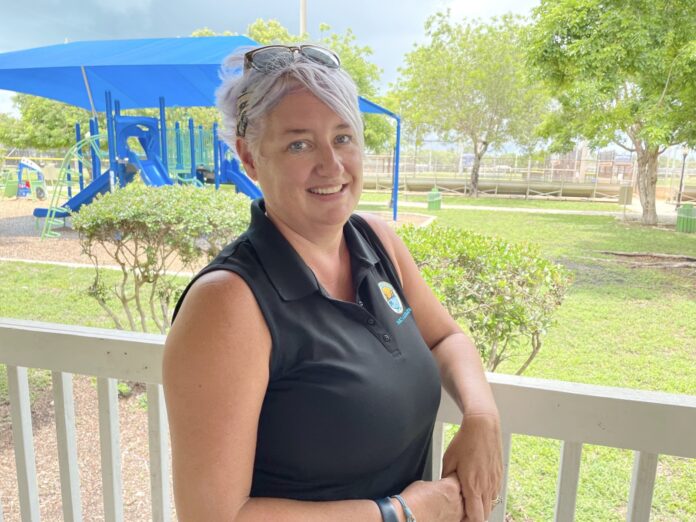 a woman with a stethoscope standing on a porch