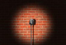 a microphone on a stand in front of a brick wall