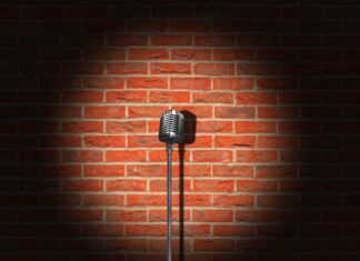 a microphone on a stand in front of a brick wall