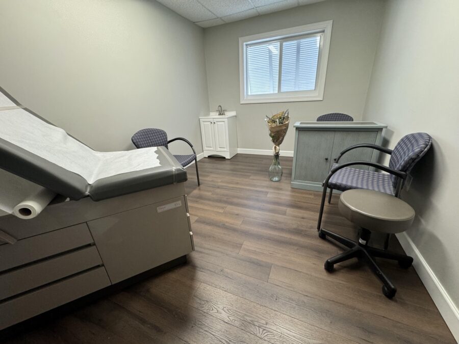 a hospital room with a bed and a chair