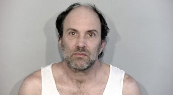 a mug shot of a man in a tank top