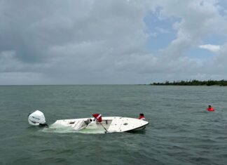 a small white boat in the middle of the ocean