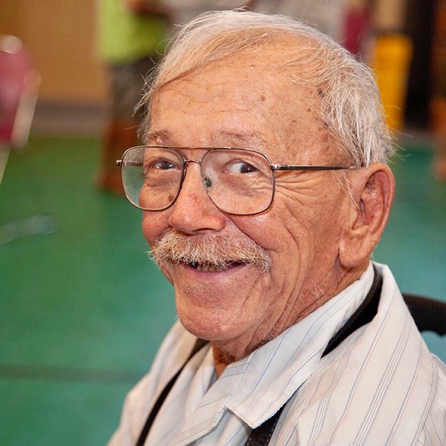 an older man with glasses and a tie