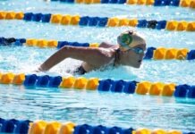 a woman swimming in a pool wearing a swimming cap