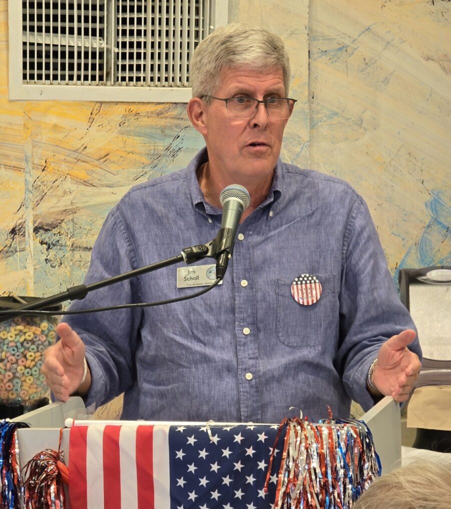 a man standing at a podium with a microphone