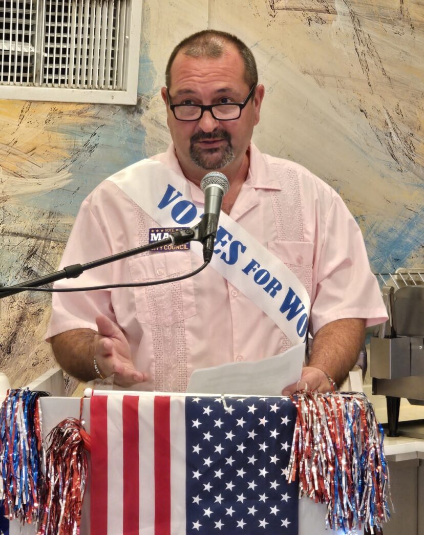 a man standing at a podium with a microphone