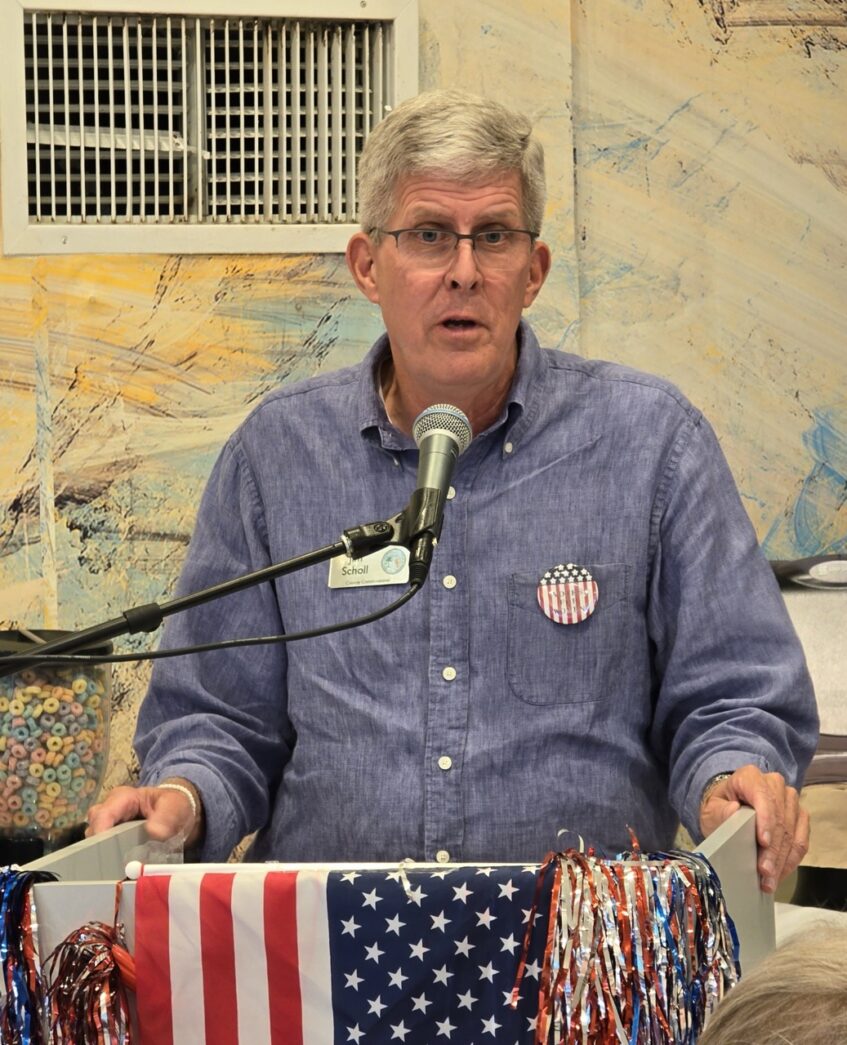 a man standing at a podium with a microphone