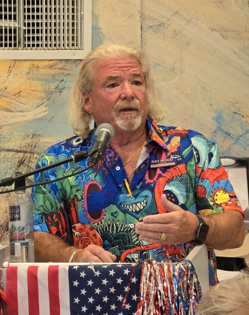 a man standing at a podium with a microphone