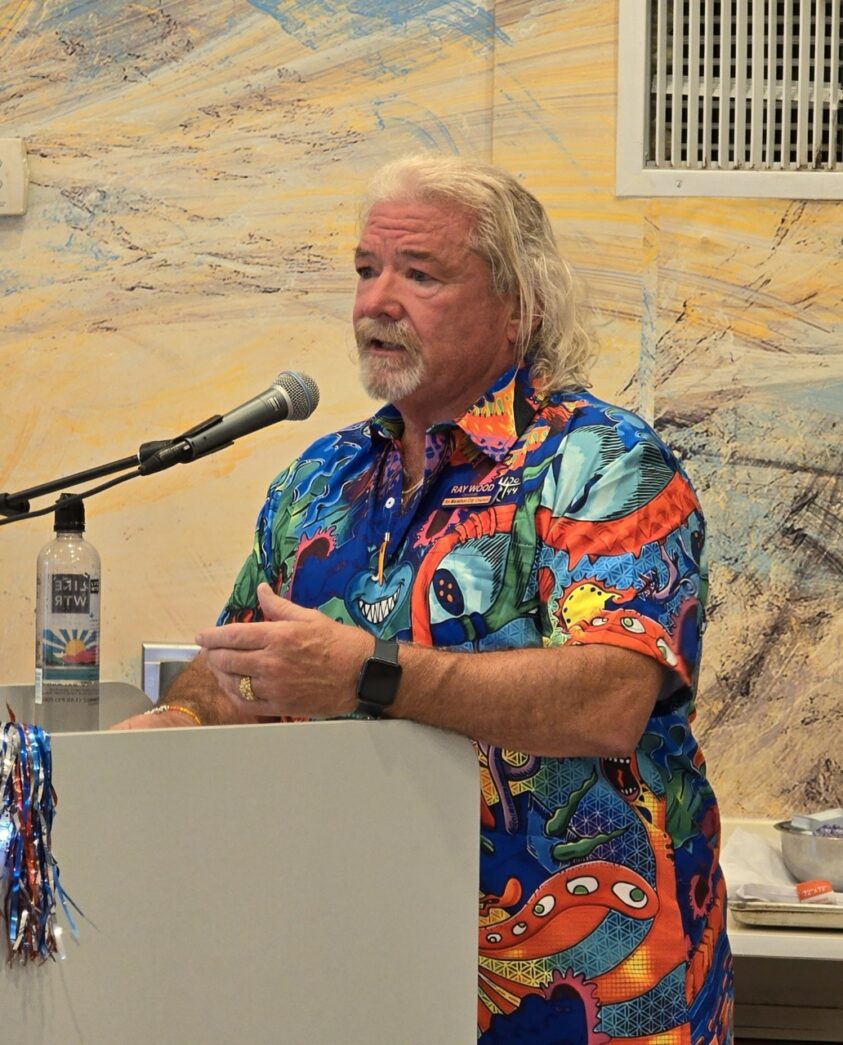 a man standing at a podium in front of a microphone