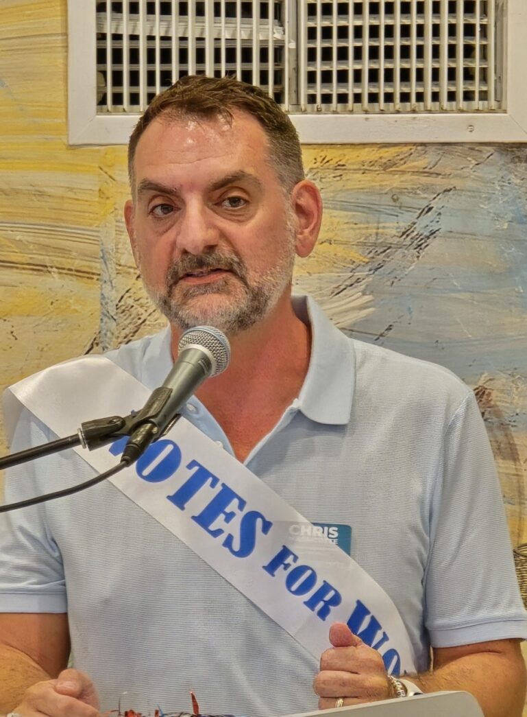 a man speaking into a microphone at a podium