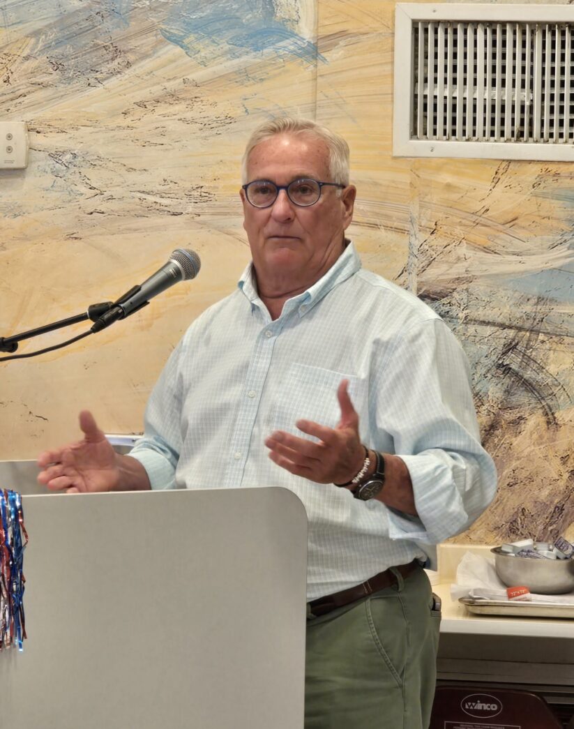 a man standing at a podium giving a speech