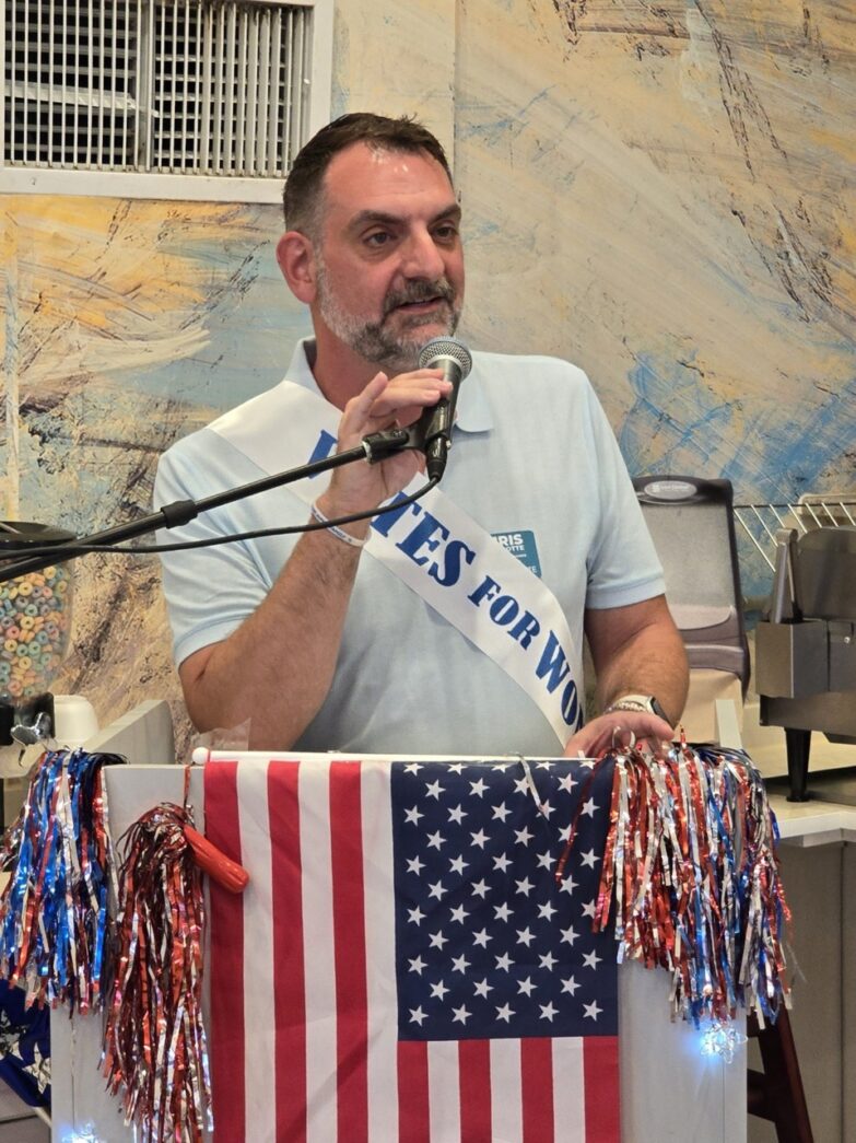 a man standing at a podium with a microphone