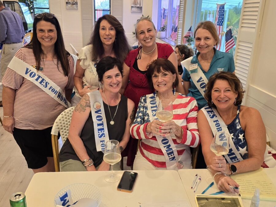 a group of women standing around a table