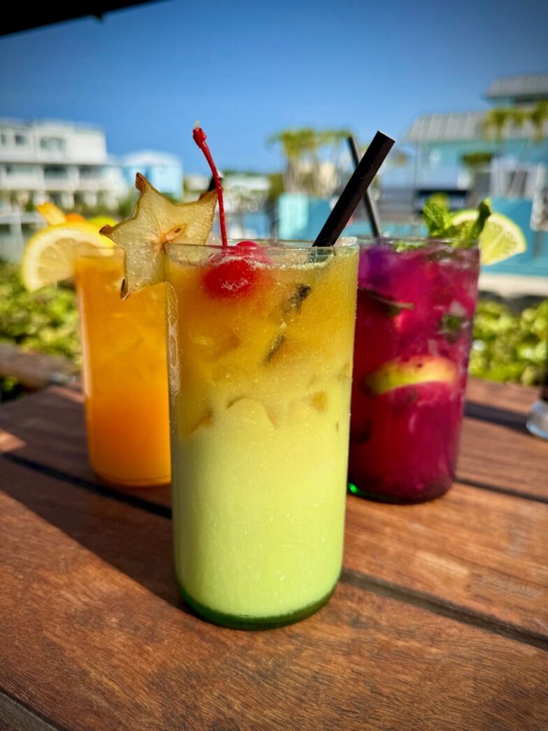 three drinks sitting on top of a wooden table