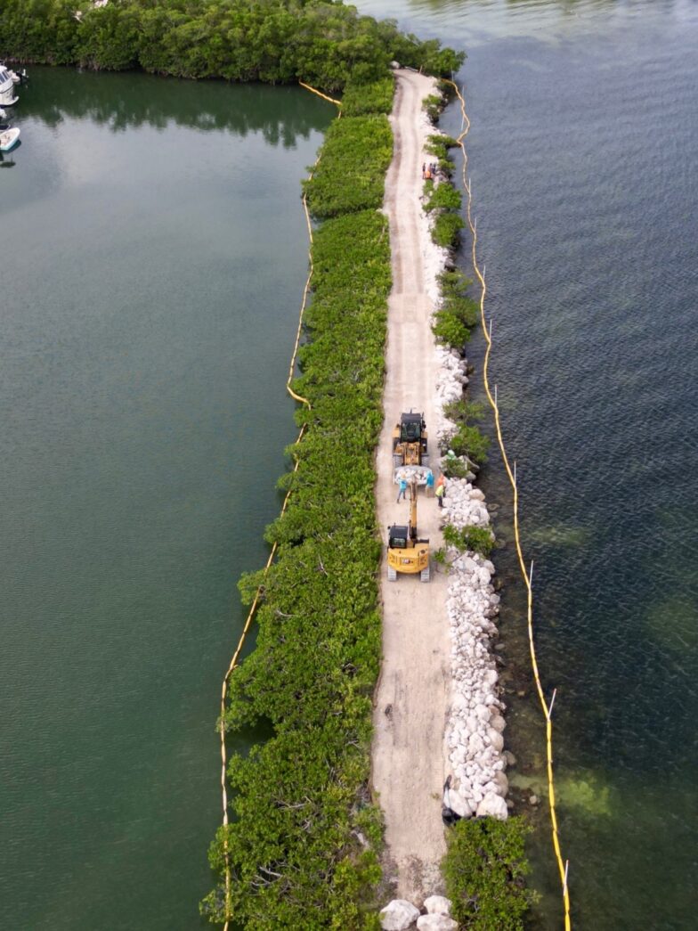 an aerial view of a long stretch of land next to a body of water