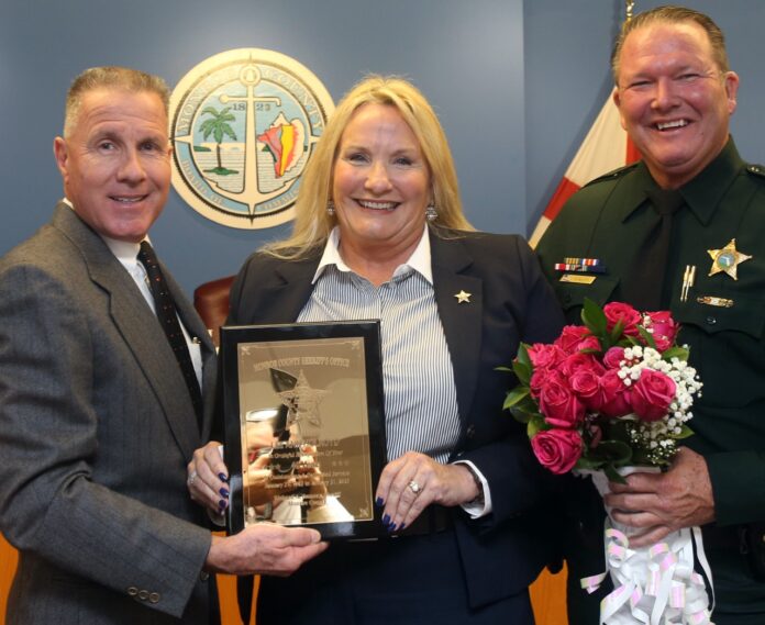 Capt. Holroyd 40 years Large two men and a woman holding a framed picture