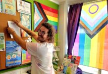 a man standing in front of a bulletin board