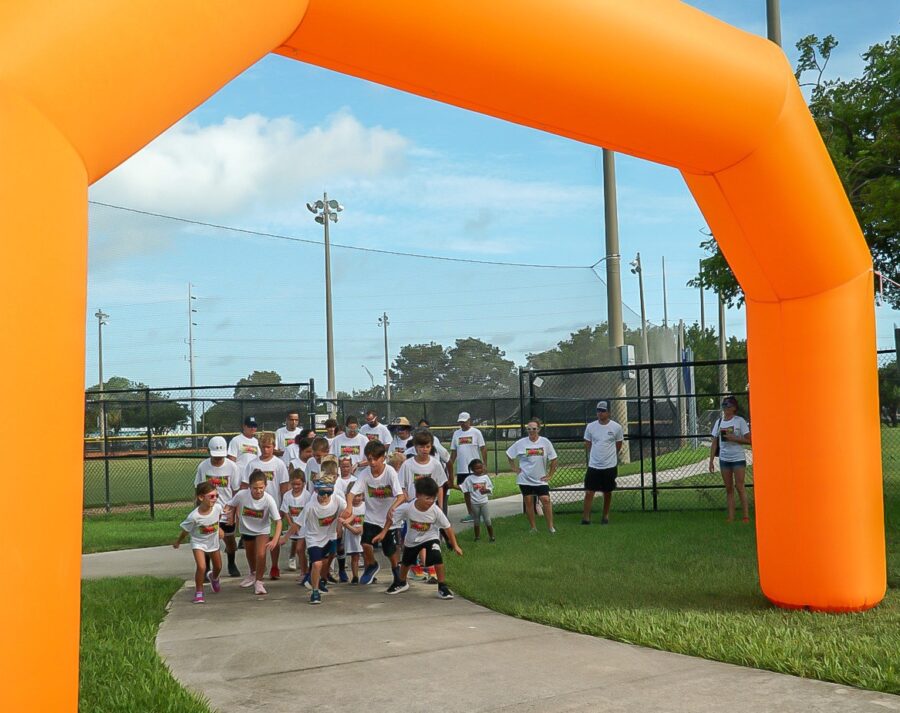 a group of people standing in front of an inflatable arch