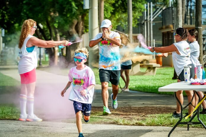 a group of people running in a park