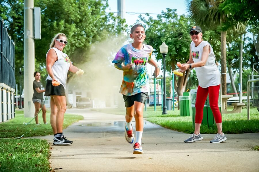 a group of people running down a sidewalk