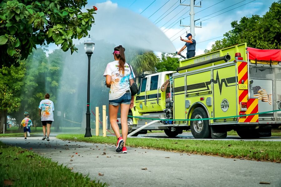 a fire truck is spraying water on a woman