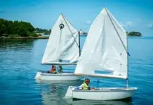 a couple of small sailboats floating on top of a body of water