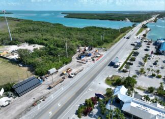 an aerial view of a road and a body of water