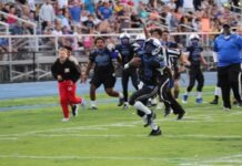 a football player running with the ball during a game