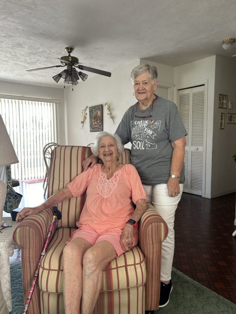 a man and a woman sitting in a chair in a living room