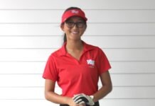 a woman wearing a red shirt and black pants