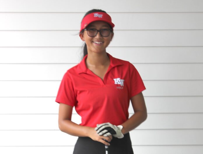 a woman wearing a red shirt and black pants
