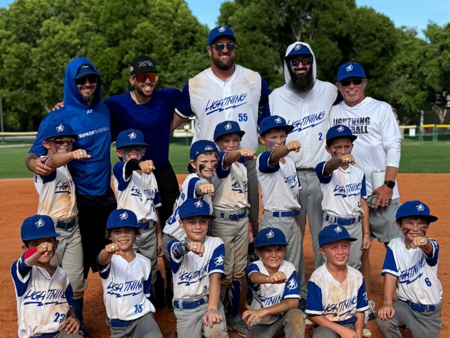 a group of young baseball players posing for a picture