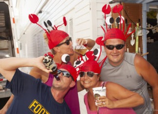 GOT BUTTER? LOBSTERFEST CELEBRATES ANOTHER SPINY LOBSTER SEASON a group of people wearing red hats and sunglasses